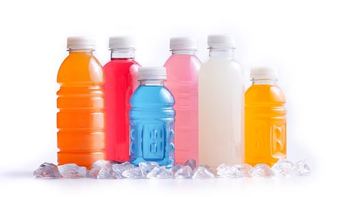 Variety of flavored sports beverages bottled and placed in ice on a white background.