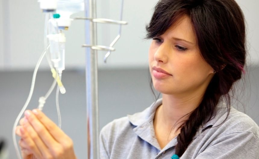 Doctor or nurse adjusting saline drip.