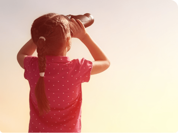Girl staring into the distance with binoculars