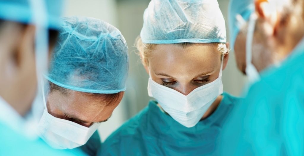 Group of doctors in scrubs and masks. 