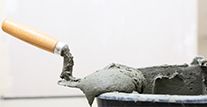 Cement mortar on trowel. 