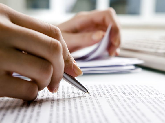 Hand with pen editing page.